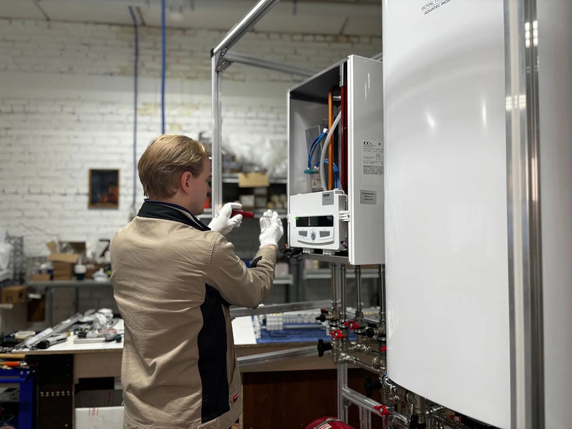 Engineer working on an open wall-mounted boiler