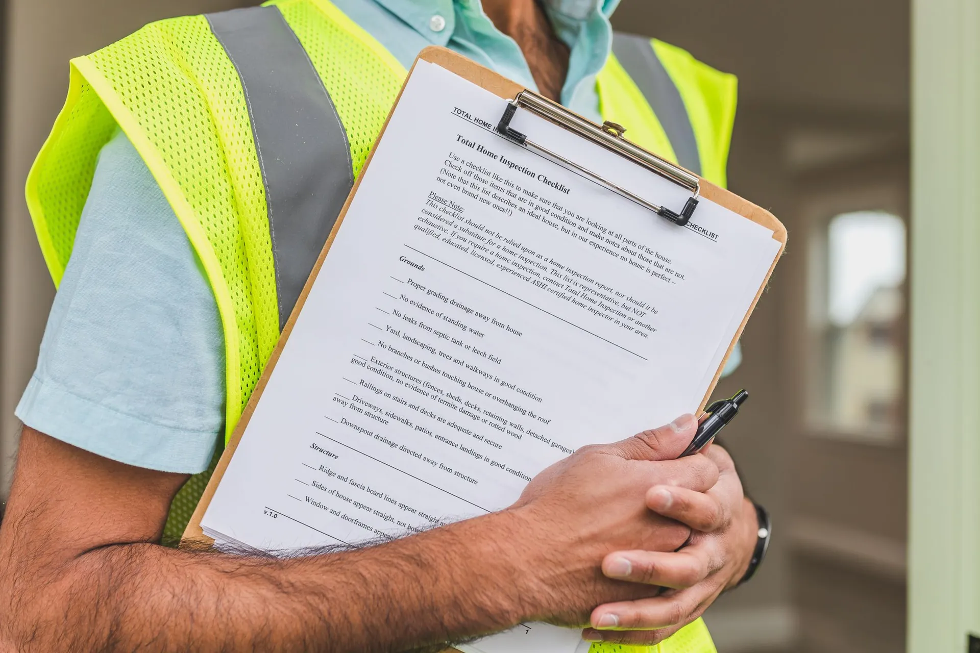 Engineer filling in a written safety inspection checklist on a clipboard