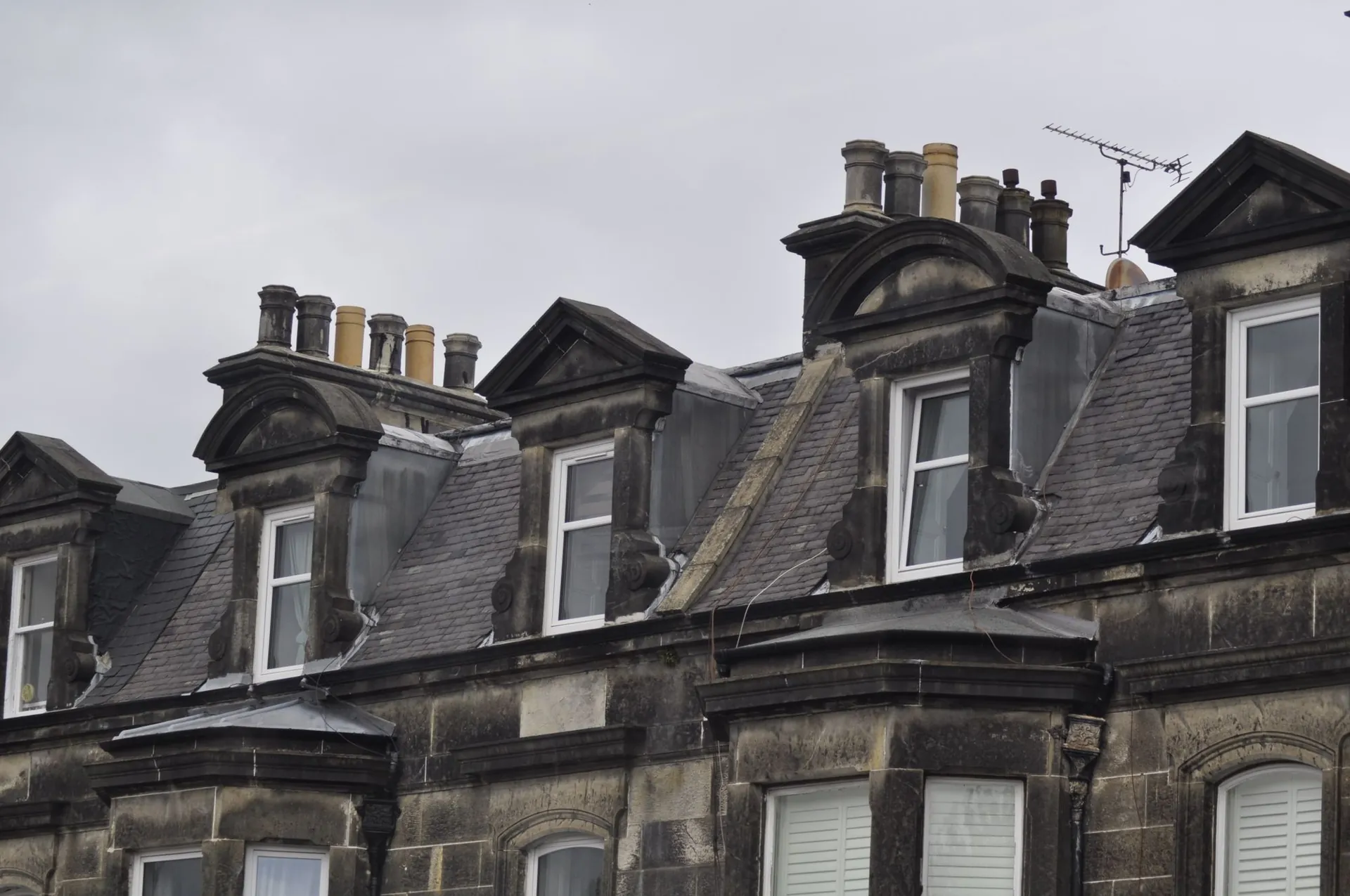 Stone-built flats with dormer windows and chimney stacks
